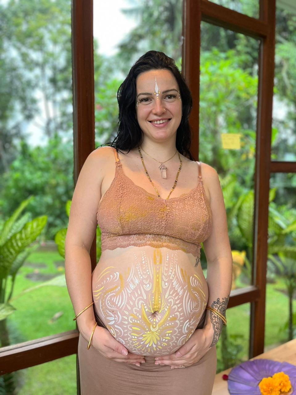 Mel, founder of Above Our Love, pregnant with ceremonial belly painting